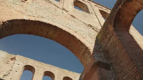 Epic Shot of Going Underneath Ancient Stone Arch Ruin Looking on Blue Sky Видео 166145238