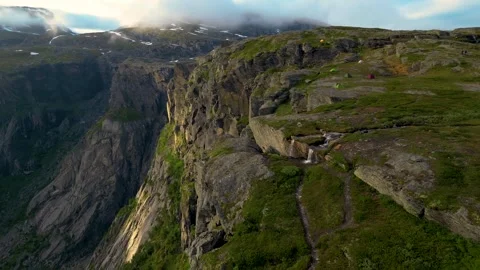 Epic Shot Over Mountain Side On Trolltunga With Tents And River 4K Areal Stock Footage 249906599