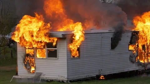 Epic slow motion shot of a trailer home on fire. House engulfed in flames with Stock Footage 229817020