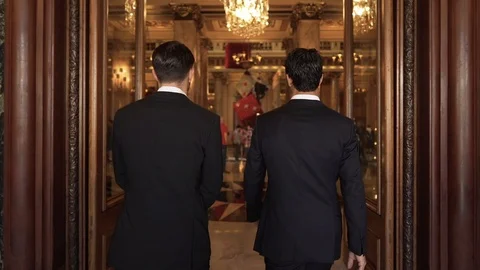 Epic slow motion shot of two men in suits entering casino hall in Monte Vídeos de archivo 124654474