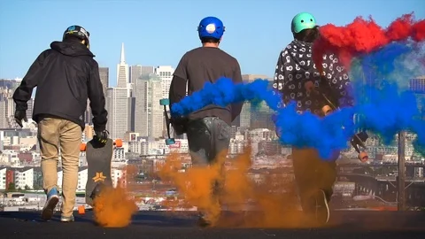 Epic slow motion video of skateboarders walking down a hill ready to longboard a Stock Footage