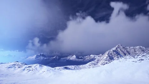 Epic Snow Covered Mountain Peaks Under Blue Sky With Dramatic Fluffy Clouds Stock Footage 338250682