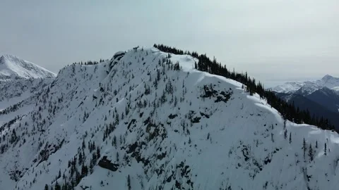 Epic snow covered mountain ridgeline, Stunning winter weather, Drone Stock Footage 289565585