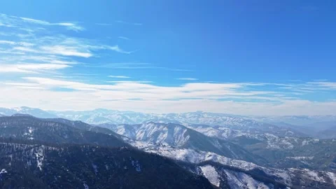 Epic Snowy Mountains with Clear Blue Sky Cinematic Aerial Landscape 4K Stock Footage 334549451