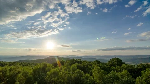 Epic sunrise with clouds sky and green forest moving in wind nature Time lapse Stock Footage 106670045