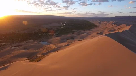 Epic sunrise over Mongolian Gobi desert sand dune windy oasis  Stock Footage 106941915