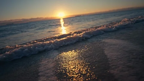 Epic Sunrise shot of waves breaking on beach with sun and colorful water Stock Footage 280507549