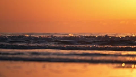 Epic Sunrise shot of waves breaking on beach with sun and colorful water 動画素材 280508232