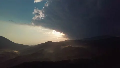 Epic sunset behind rainy clouds and fog on hills in the mountains of balkan in G Stock Footage 130537965