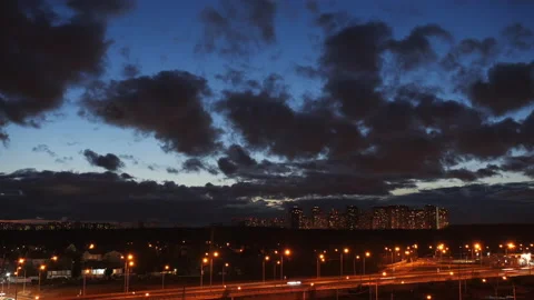 Epic sunset clouds in the sky above city skyline silhouette and highway traffic Stock Footage 132279585