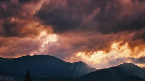 Epic sunset clouds with sun rays emerging though the dark storm clouds Stock Footage 155144440