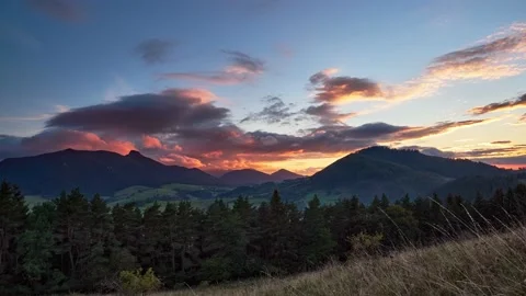 Epic sunset with colorful clouds in beautiful mountain countryside. 4K timelapse 動画素材 218496752
