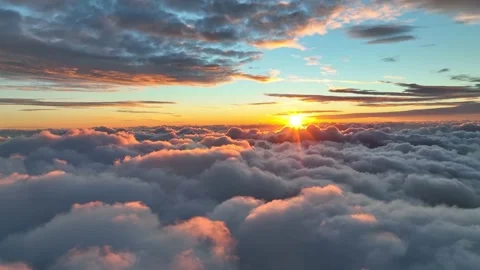 Epic sunset over the clouds. Warm sun sets over the horizon in clouds. Flight in Stock Footage 221248075