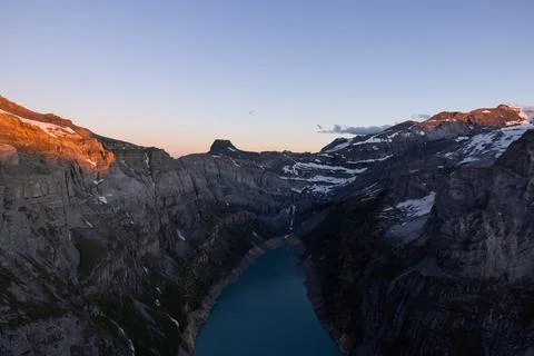 Epic sunset over the Glarner Alps at an Alpine lake called Limmerensee. Stock Photos