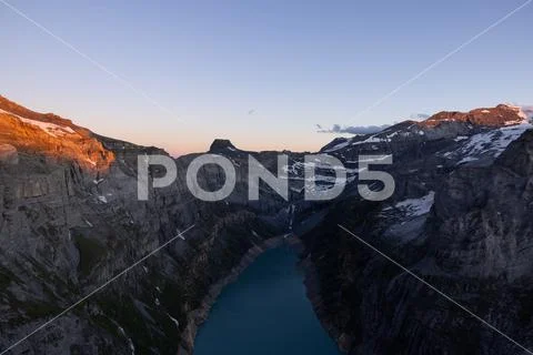 Epic sunset over the Glarner Alps at an Alpine lake called Limmerensee.