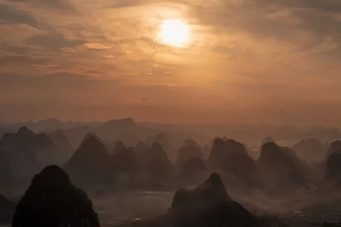 Epic Sunset over Karst Mountains with Advection Fog and Sun Rays 4K Timelaps Stock Footage 340410973