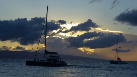 Epic Sunset Over Ocean, Sailboat Cruises By, Two Boats Anchored In Distance Stock Footage 73563496
