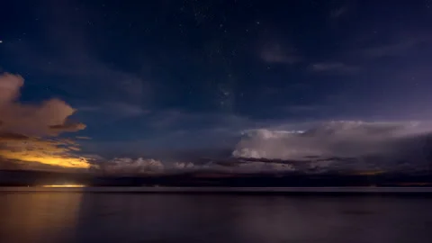 Epic timelapse view over Uyuni salt flats with lightning strikes and starry sky Stock Footage 326342717