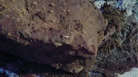 Epic video lying on the edge of a cliff by the sea Stock Footage 228668393