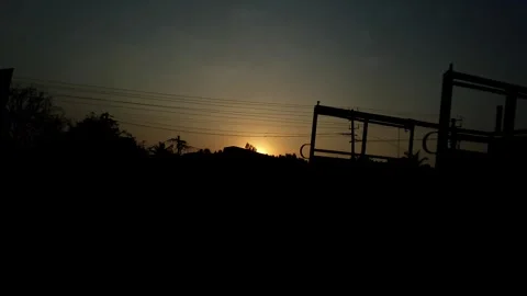 An epic view of a dark sunset over fields as seen from a speeding train.sunset Stock Footage 313381041