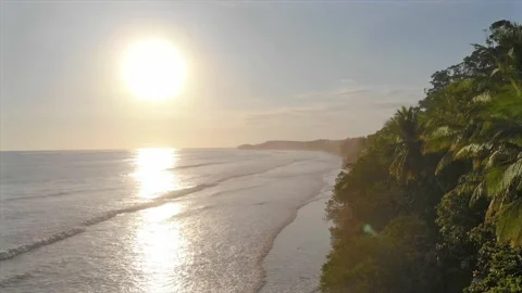 Epic view with sun flare of stunning tropical beach paradise at golden hour Stock Footage 154341397