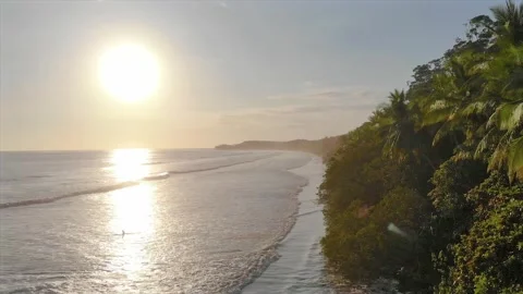 Epic view with sun flare of stunning tropical beach paradise at golden hour Stock Footage 154342072