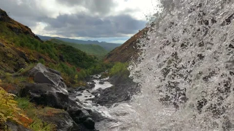 Epic view from under the waterfall to the mountain valley and river Stock-Footage 140577325