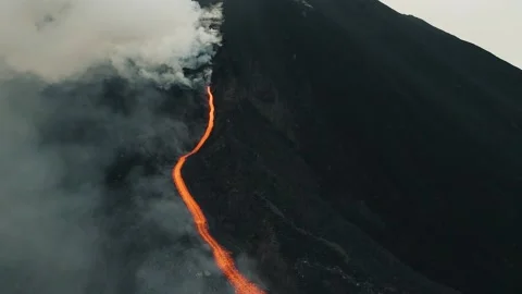 Epic Volcanic Eruption Streams Lava Through Clouds in 4K UHD Stock Footage 329198965
