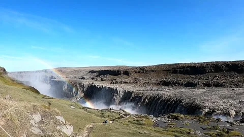 Epic wide-angle view of Dettifoss waterfall with vibrant double rainbow Stock Footage 333514098