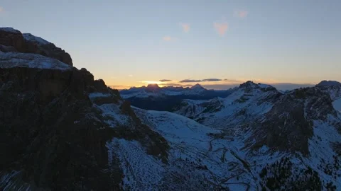 Epic Winter Sunset Over Snowy Alpine Peaks and Winding Mountain Road Stock Footage 320655879
