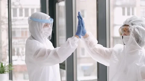 Epidemiologists in full covering suit clapping hands Stock Footage 143570745