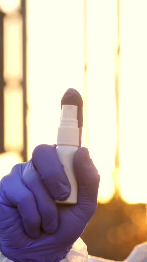 Epidemiologist's hand spraying disinfectant Stock Footage 302385254