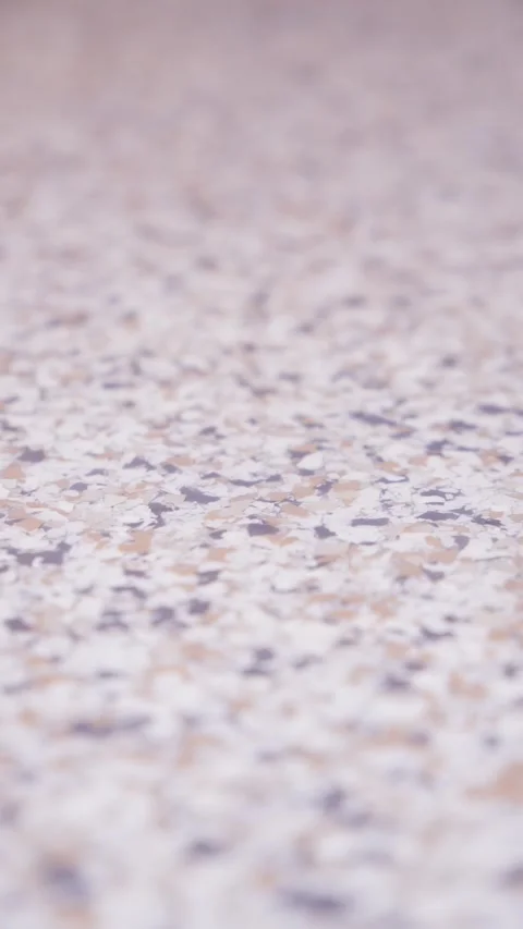 Epoxy floor with reflective surface and colorful flake texture vertical video Stock Footage 323772566