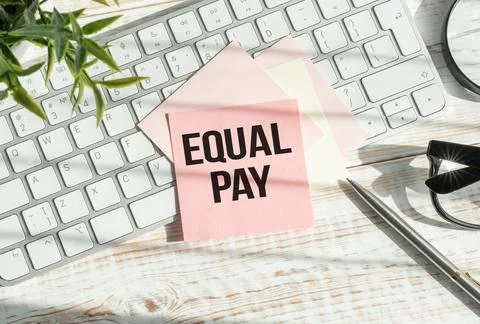 Equal Pay text on a clipboard with chart on white background, business concep Stock Photos