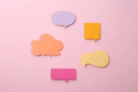 Equality concept. Different paper speech bubbles on pink background, flat lay Stock Photos