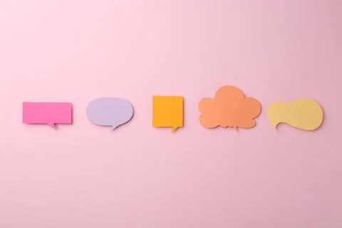 Equality concept. Different paper speech bubbles on pink background, flat lay Stock Photos