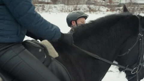 Equestrian scene overview. Snowy riding session with horse. Focus on rider pose Stock Footage 346247172