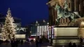 Equestrian statue and illuminated Christmas tree with busy street life traffic 4k or 4k+ Resolution