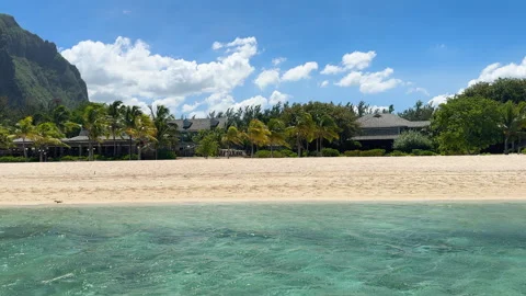 Equestrians galloping on the white sand beaches of Le Morne, Mauritius, on a Stock Footage 314942206