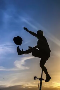 Equilibrist on a unicicle performing at sunset Stock Photos