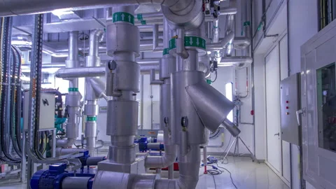 Equipment, cables and piping as found inside of industrial chiller plant room Stock Footage 173420095