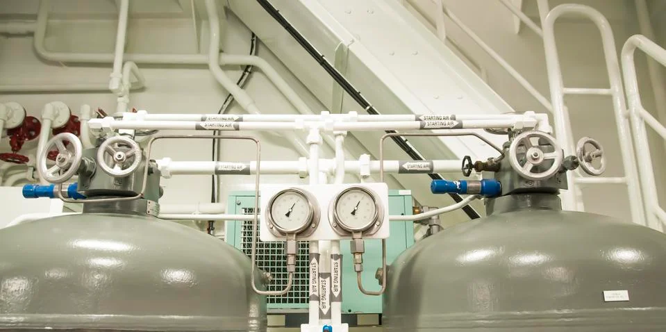 Equipment, cables, pipes and valves in engine room of a ship power plant Stock Photos