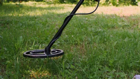 An equipment for finding metals is moving over ground for searching Stock Footage 166611322