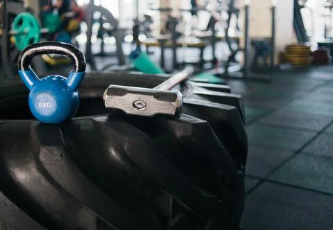 Equipment for functional training. Large rubber wheel, hammer, kettlebell clo 库存照片