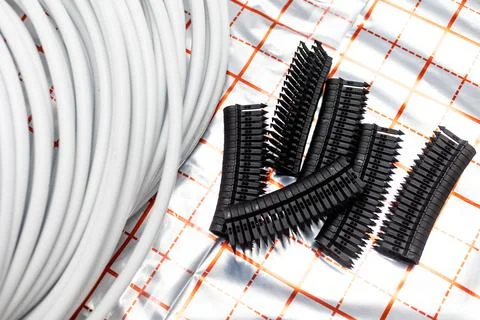 Equipment for installing underfloor heating, stapler with plastic buckles or Stock Photos