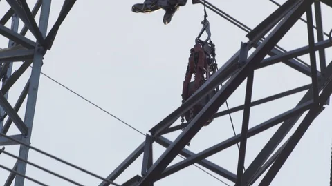 Equipment is lowered down from electrical pole Stock Footage 121913821