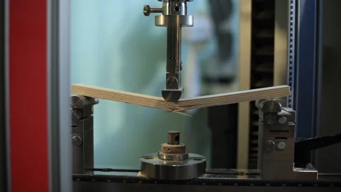 Equipment for mechanical testing of materials pushed on the piece of plywood Stock Footage 92200054