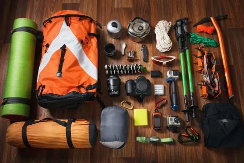 Equipment necessary for mountaineering and hiking on wooden background Stock Photos