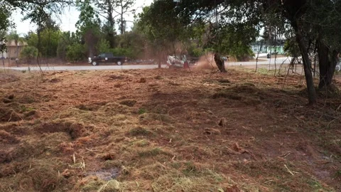 Equipment Stirring Dust as It Clears a Lot Near a Quiet Road Stock-Footage 334012408