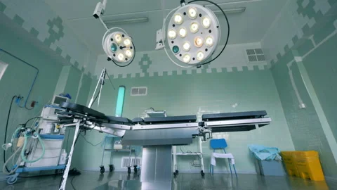 Equipped delivery room with two functioning surgical lamps Stock Footage 94538291